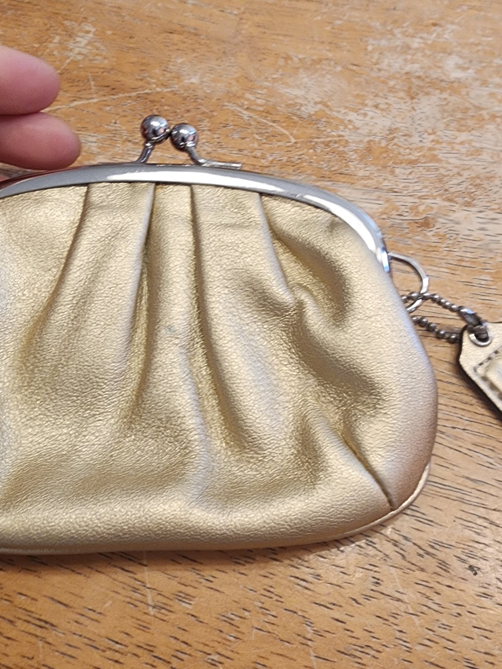Coach metallic gold leather kisslock frame coin purse.